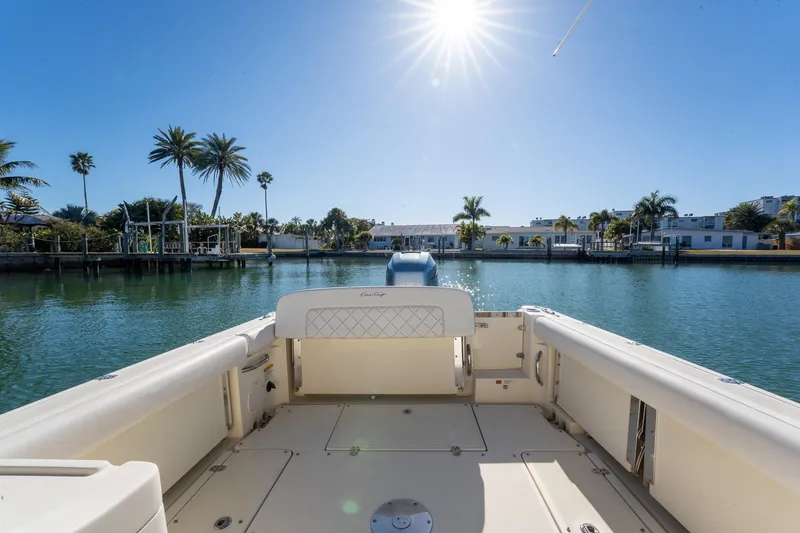 Slide: The Image of 2018 Chris-Craft Calypso 26 boat on sunny waterway with palm trees. - 16