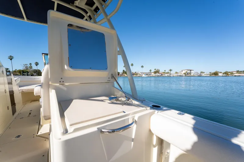 Slide: The Image of 2018 Chris-Craft Calypso 26 boat interior with waterfront view, clear blue sky. - 21
