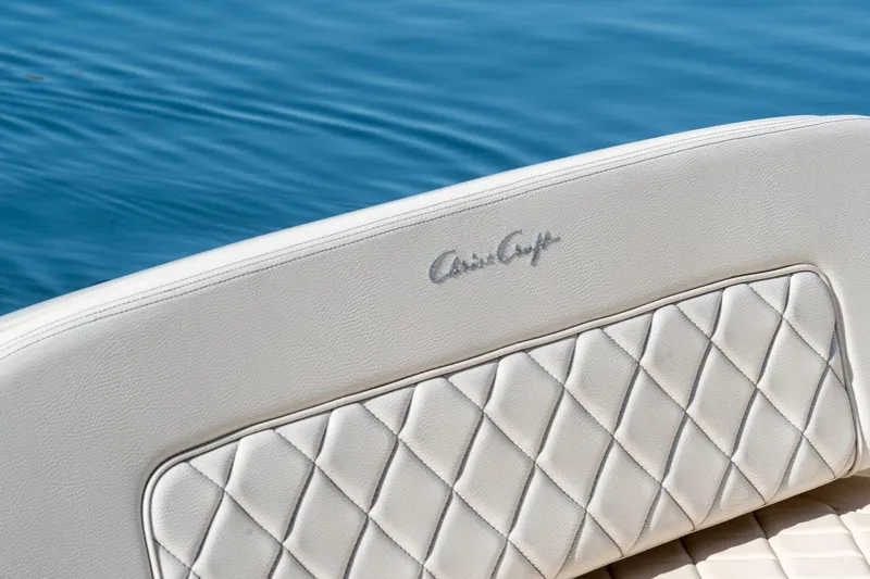 Slide: The Image of 2018 Chris-Craft Calypso 26 boat seat with quilted leather design on blue water. - 22