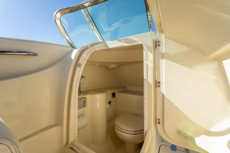 Slide: The Image of 2018 Chris-Craft Calypso 26 boat interior bathroom with toilet and sink. - 33