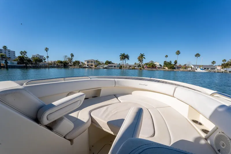 Slide: The Image of 2018 Chris-Craft Calypso 26 boat interior with waterfront view and palm trees. - 34