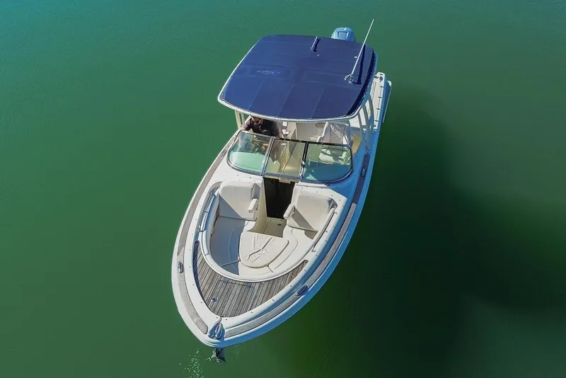 Slide: The Image of Aerial view of a 2018 Chris-Craft Calypso 26 on calm water. - 40