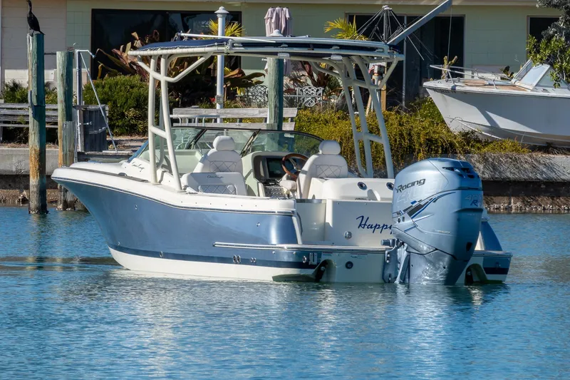 Slide: The Image of 2018 Chris-Craft Calypso 26 boat on water, featuring sleek design and powerful outboard engine. - 5