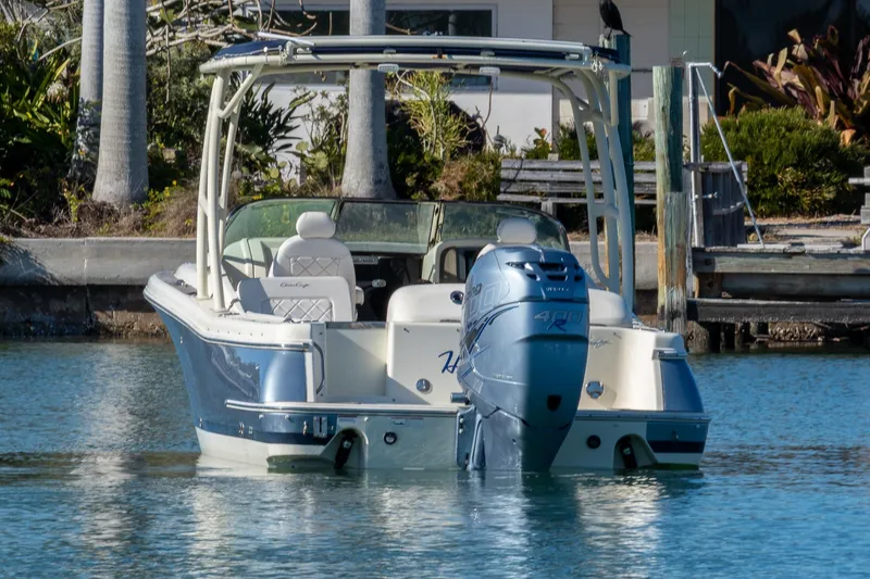 Slide: The Image of 2018 Chris-Craft Calypso 26 boat with Yamaha engine, docked in calm waters. - 6