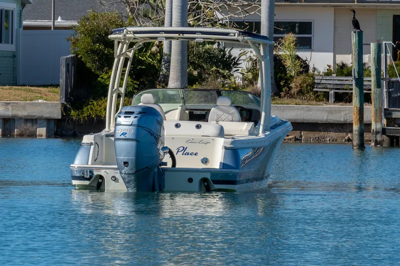 Slide: The Image of 2018 Chris-Craft Calypso 26 boat on calm water near a dock. - 7