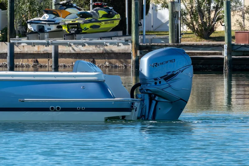 Slide: The Image of 2018 Chris-Craft Calypso 26 boat with powerful outboard engine on calm water. - 9