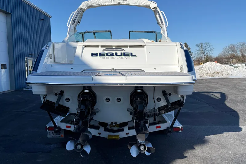 Slide: The Image of 2007 Formula 280 Bowrider boat rear view with dual propellers, parked outdoors. - 2
