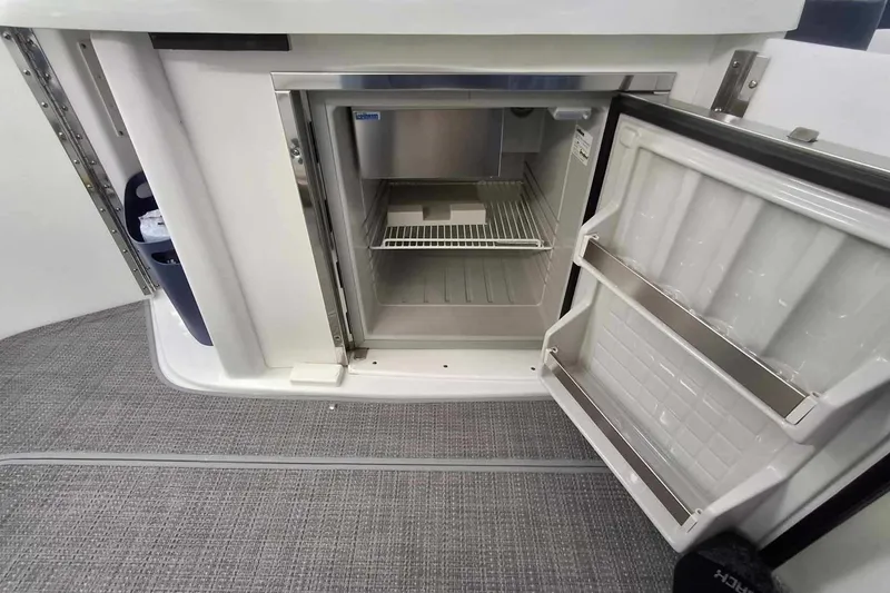 Slide: The Image of Open mini fridge on 2007 Formula 280 Bowrider boat, showing interior shelves. - 21