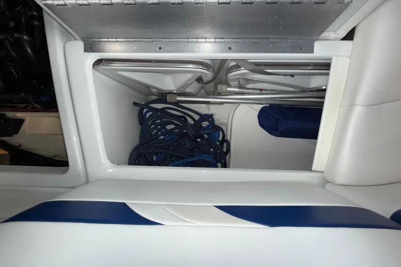 Slide: The Image of Storage compartment in a 2007 Formula 280 Bowrider boat with coiled rope. - 25