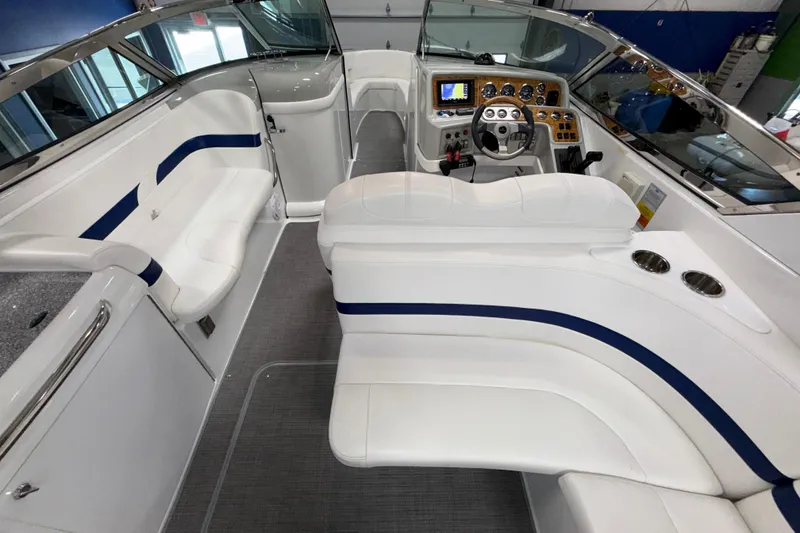 Slide: The Image of 2007 Formula 280 Bowrider interior with white seating, blue accents, and modern dashboard. - 34