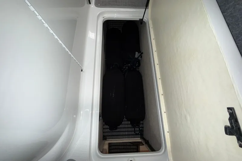 Slide: The Image of Storage compartment in a 2007 Formula 280 Bowrider boat, featuring organized interior space. - 35
