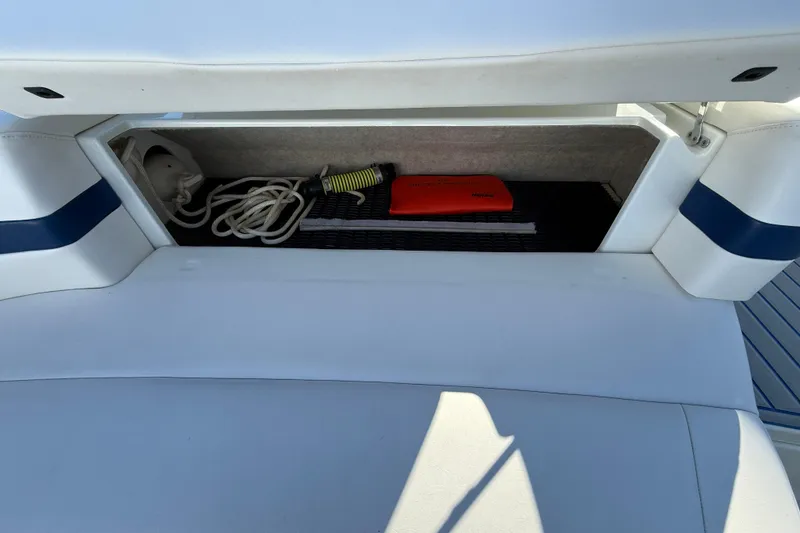 Slide: The Image of Storage compartment in a 2007 Formula 280 Bowrider boat with rope and safety equipment. - 41
