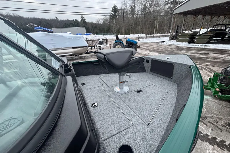 Slide: The Image of 2026 Lund 1650 Rebel XL Sport boat with seating, parked in snowy outdoor setting. - 13