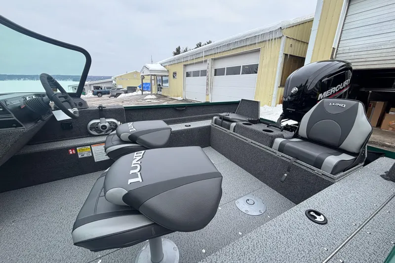 Slide: The Image of 2026 Lund 1650 Rebel XL Sport boat interior with seating and Mercury engine. - 8