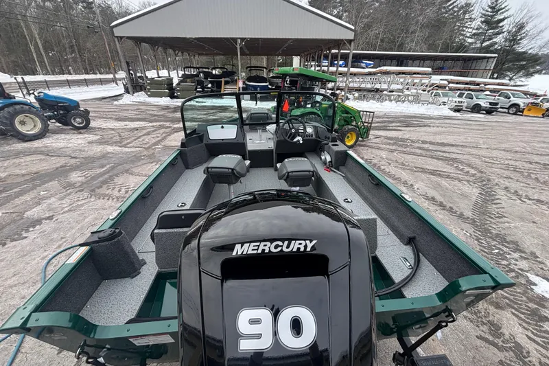 Slide: The Image of 2026 Lund 1650 Rebel XL Sport boat with Mercury 90 engine, parked outdoors in snowy setting. - 9