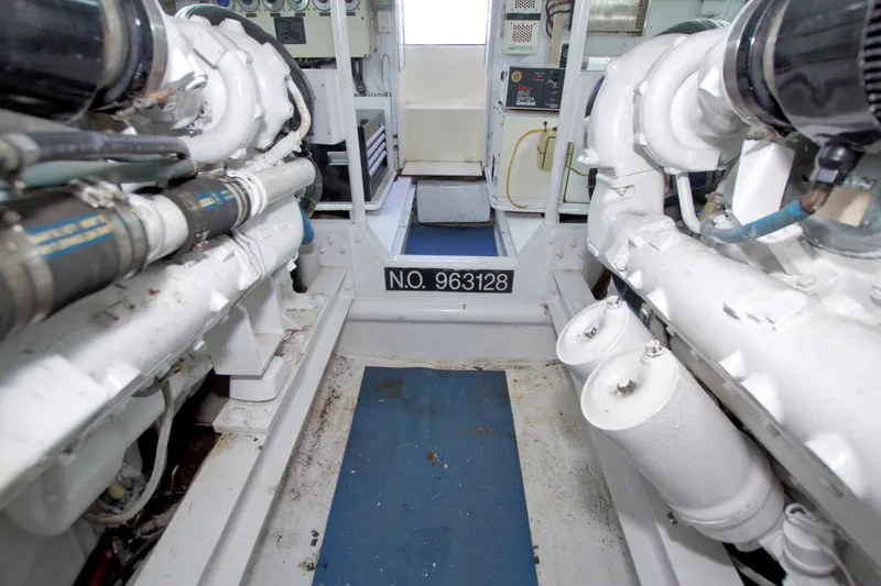 Slide: The Image of Engine room of 1990 Viking 53 Convertible yacht, showcasing machinery and equipment. - 100