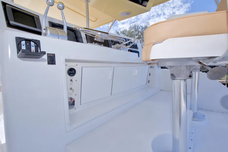 Slide: The Image of 1990 Viking 53 Convertible yacht helm with controls and seating, featuring modern navigation equipment. - 26