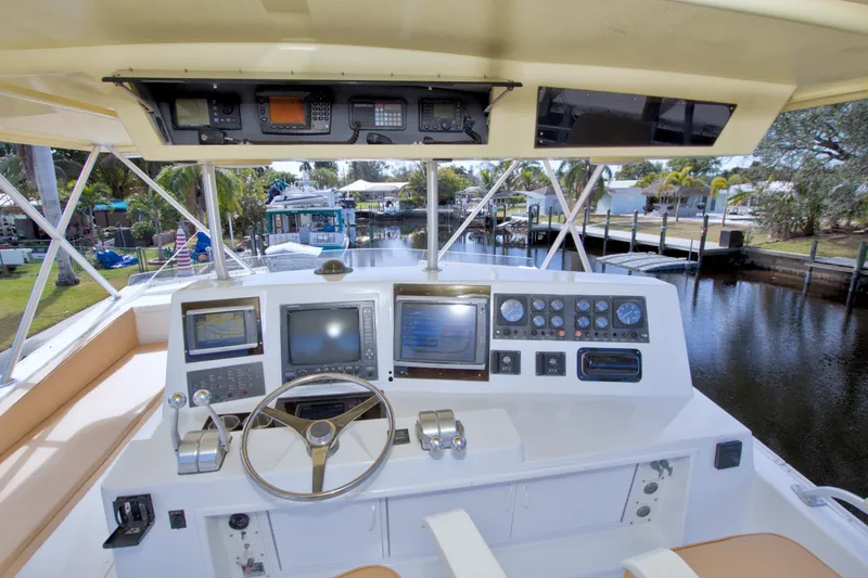 Slide: The Image of 1990 Viking 53 Convertible yacht helm with navigation instruments and steering wheel. - 27
