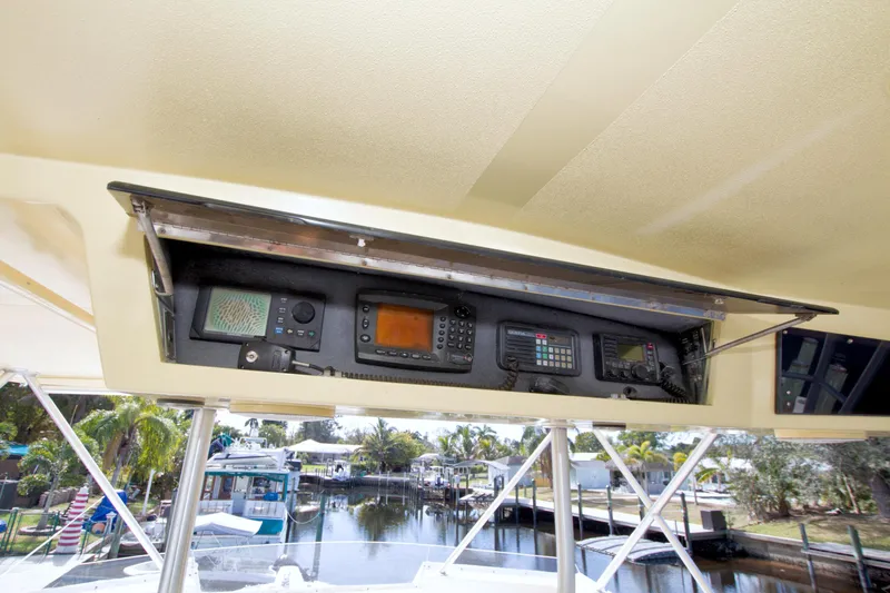 Slide: The Image of 1990 Viking 53 Convertible boat dashboard with navigation and communication equipment. - 28