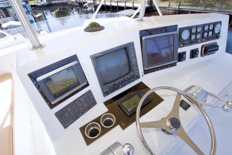 Slide: The Image of Control panel of a 1990 Viking 53 Convertible yacht with navigation equipment. - 30
