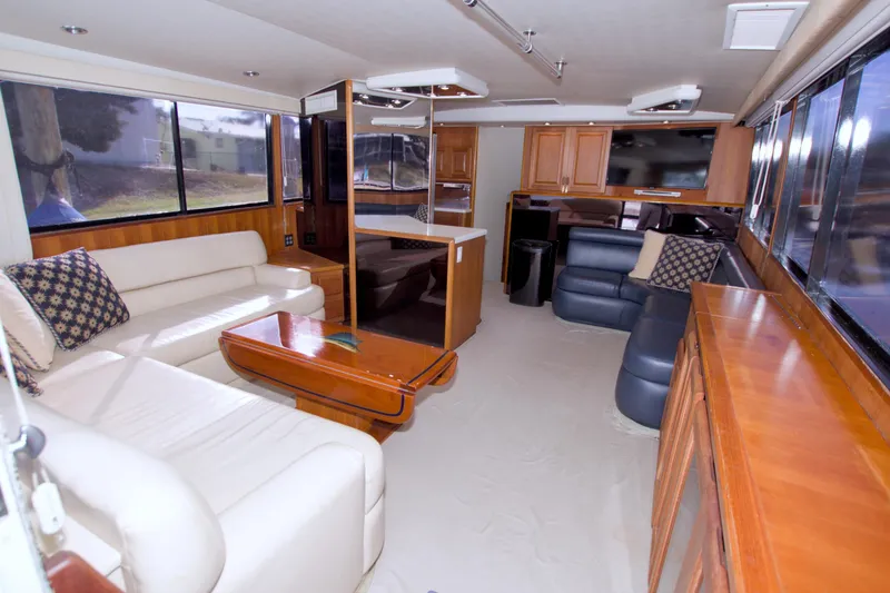 Slide: The Image of Luxurious interior of a 1990 Viking 53 Convertible yacht with elegant seating and wood finishes. - 39