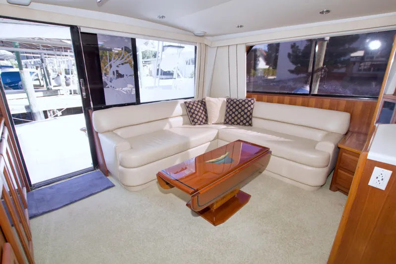 Slide: The Image of Luxurious interior of 1990 Viking 53 Convertible yacht with leather seating and wooden table. - 40