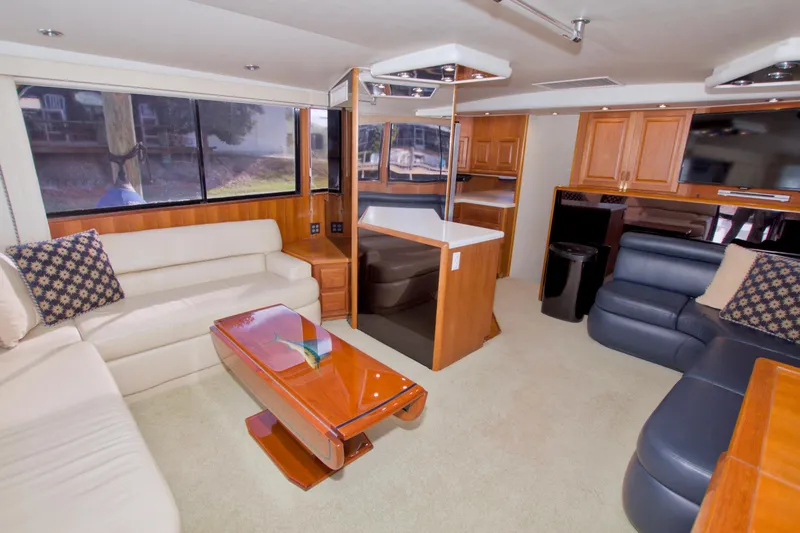 Slide: The Image of Luxurious interior of a 1990 Viking 53 Convertible yacht with elegant seating and wood finishes. - 41