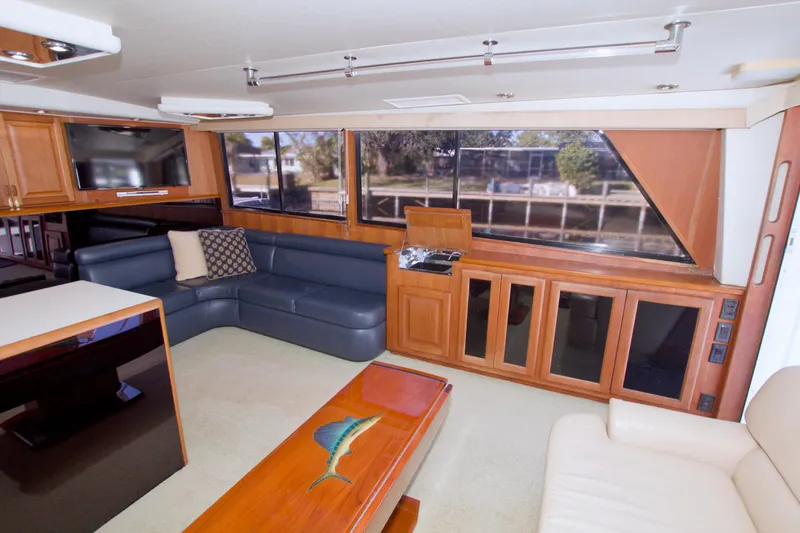 Slide: The Image of Luxurious interior of a 1990 Viking 53 Convertible yacht with leather seating and wood accents. - 42