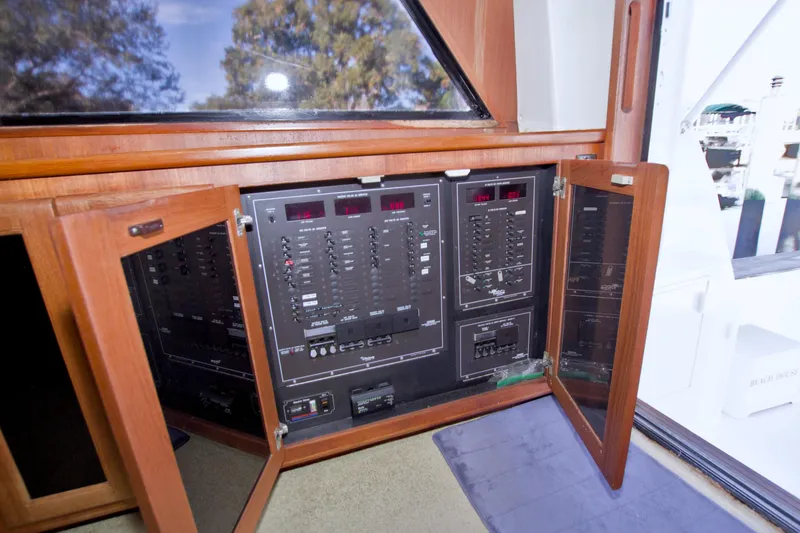 Slide: The Image of Electrical panel inside a 1990 Viking 53 Convertible yacht, featuring wooden cabinetry. - 43