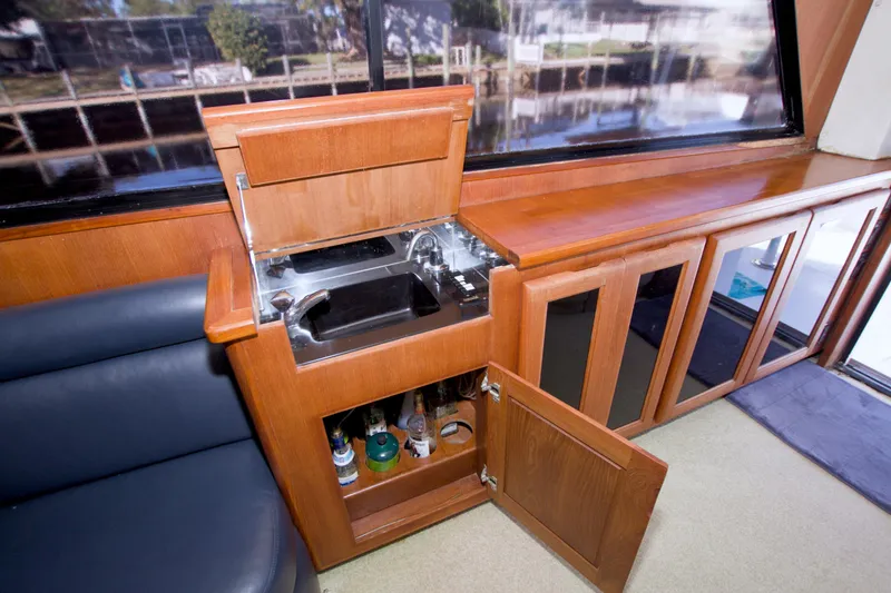 Slide: The Image of Interior of 1990 Viking 53 Convertible yacht with wooden cabinetry and built-in sink. - 44