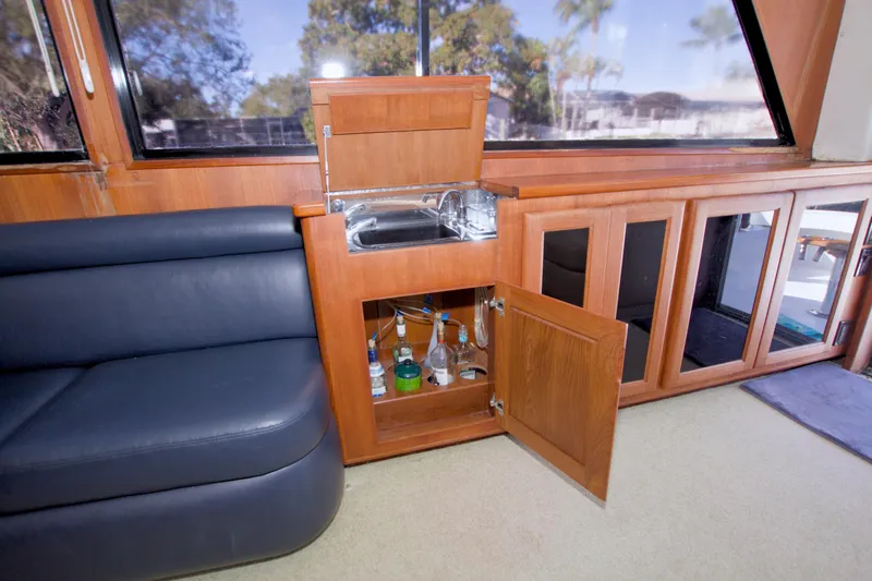 Slide: The Image of Interior of 1990 Viking 53 Convertible yacht with bar and seating area. - 45