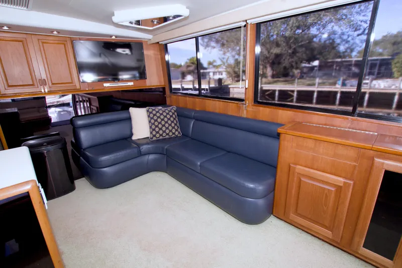 Slide: The Image of Luxurious interior of a 1990 Viking 53 Convertible yacht with blue leather seating. - 46