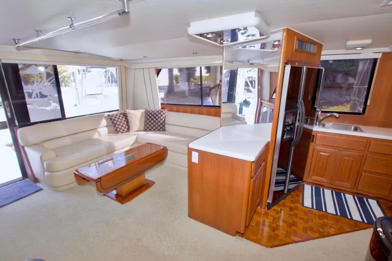 Slide: The Image of Luxurious interior of a 1990 Viking 53 Convertible yacht with modern kitchen and seating area. - 47