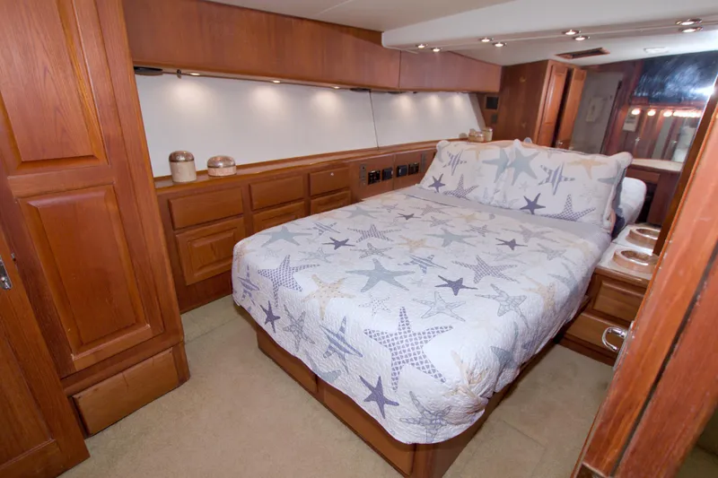 Slide: The Image of Luxurious bedroom interior of 1990 Viking 53 Convertible yacht with starfish-themed bedding. - 55