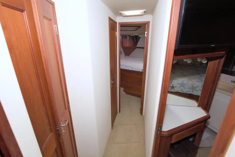 Slide: The Image of Interior hallway of 1990 Viking 53 Convertible yacht with wooden doors and cozy bedrooms. - 60