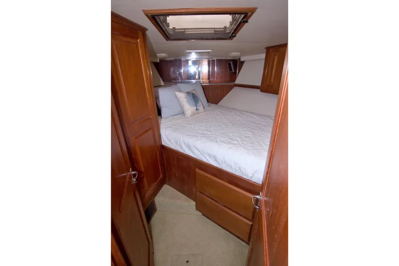 Slide: The Image of Cozy bedroom in 1990 Viking 53 Convertible yacht with wooden cabinetry and skylight. - 65