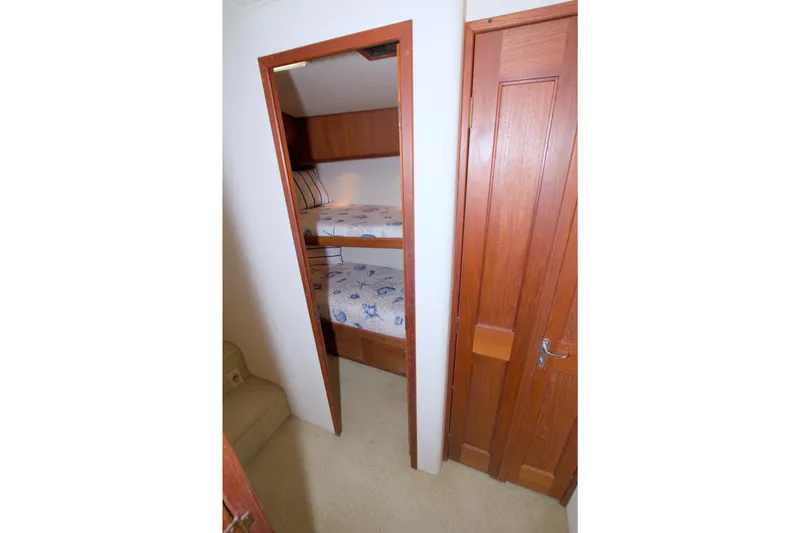 Slide: The Image of Bunk beds in 1990 Viking 53 Convertible yacht cabin with wooden interior. - 72