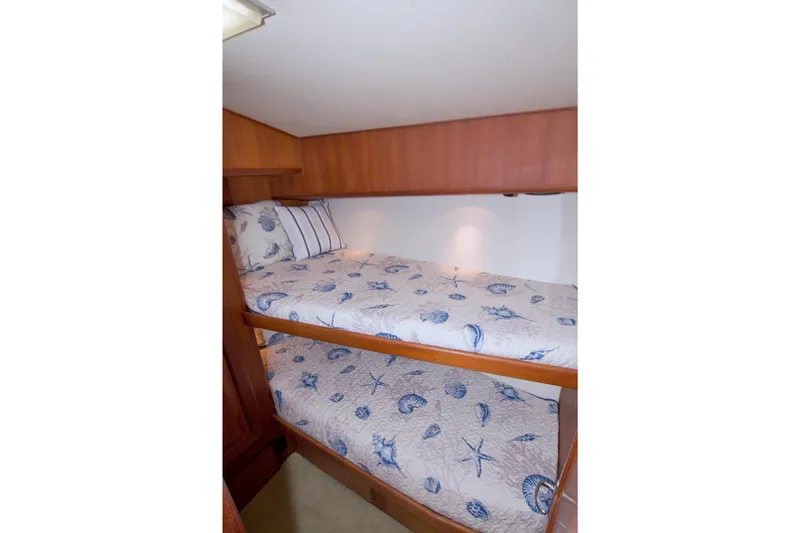 Slide: The Image of Bunk beds in 1990 Viking 53 Convertible yacht cabin with nautical-themed bedding. - 73