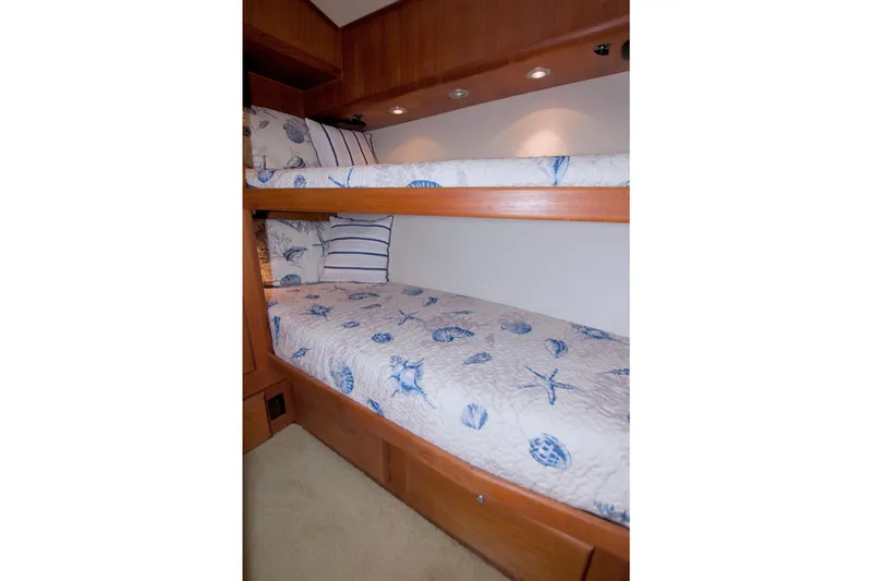 Slide: The Image of Bunk beds with nautical-themed bedding in 1990 Viking 53 Convertible yacht cabin. - 74