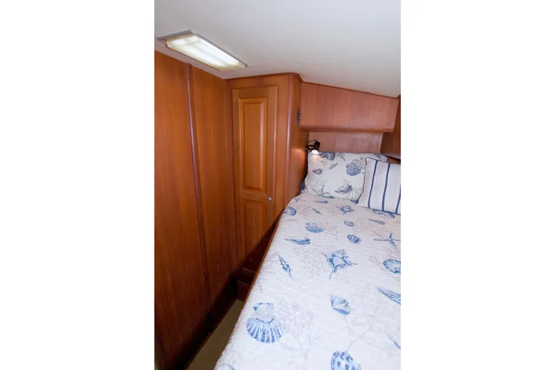 Slide: The Image of Cozy cabin interior of 1990 Viking 53 Convertible with nautical-themed bedding. - 75