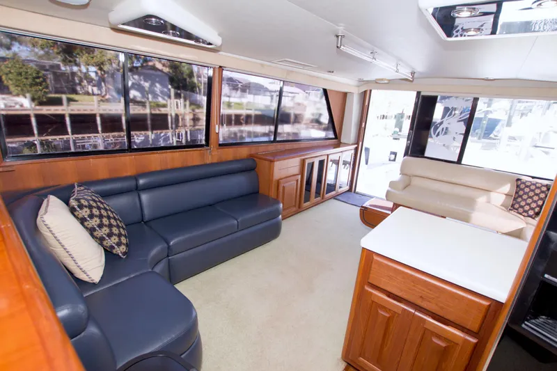 Slide: The Image of Luxurious interior of a 1990 Viking 53 Convertible yacht with plush seating and elegant wood finishes. - 76