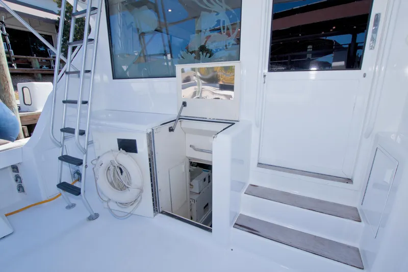 Slide: The Image of 1990 Viking 53 Convertible yacht deck with ladder and storage compartment. - 77