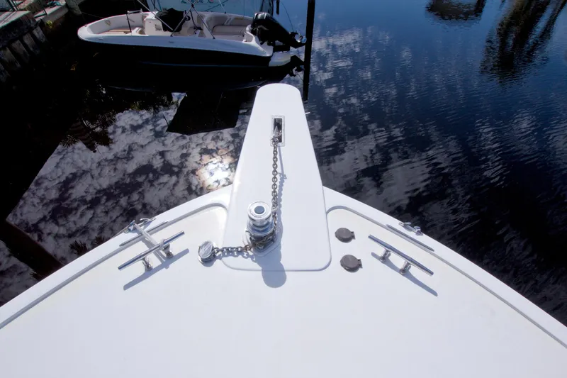 Slide: The Image of Bow of 1990 Viking 53 Convertible yacht with anchor chain, reflecting sky. - 8