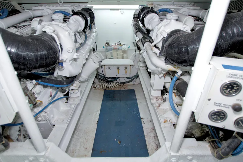 Slide: The Image of Engine room of a 1990 Viking 53 Convertible yacht, showcasing dual engines and control panel. - 88