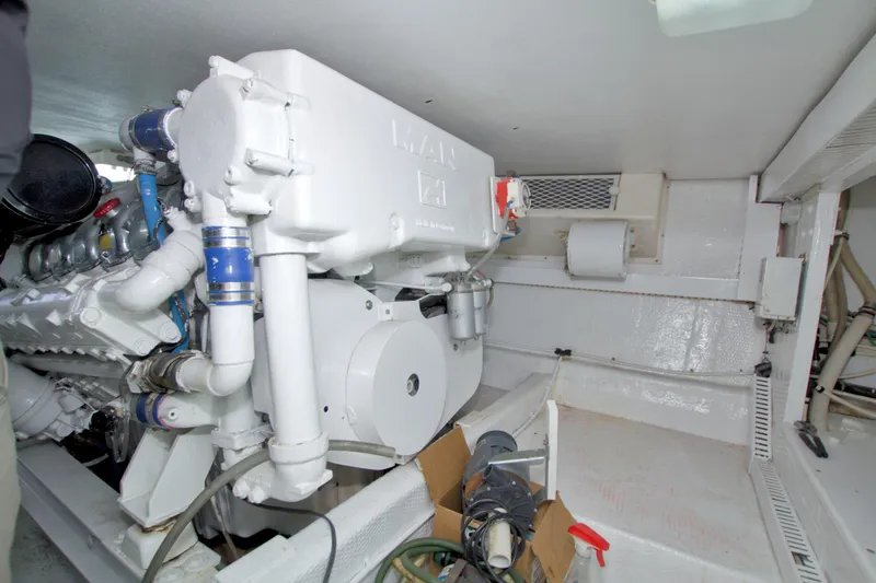 Slide: The Image of Engine room of a 1990 Viking 53 Convertible yacht, showcasing machinery and components. - 90