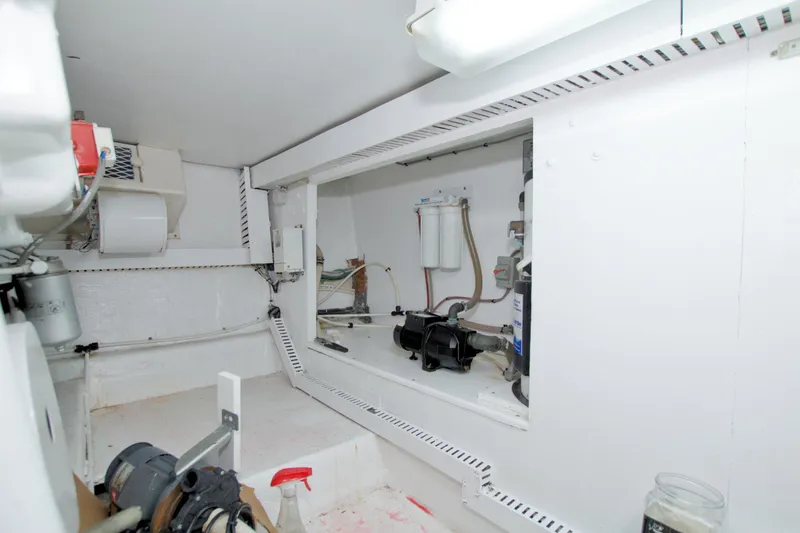 Slide: The Image of Engine room of a 1990 Viking 53 Convertible yacht, showcasing mechanical components. - 97