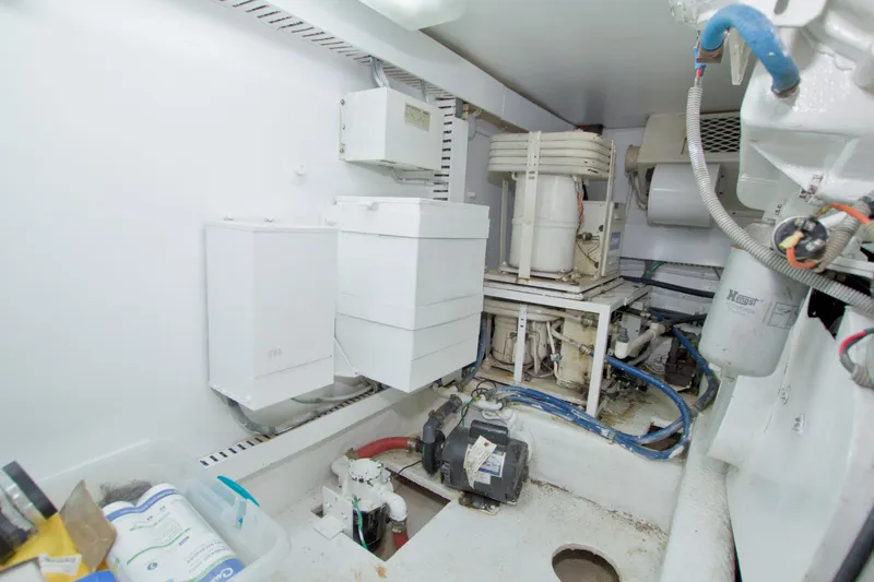 Slide: The Image of Engine room of a 1990 Viking 53 Convertible yacht, showcasing mechanical components and wiring. - 98