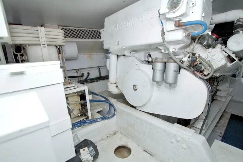 Slide: The Image of Engine room of a 1990 Viking 53 Convertible yacht, showcasing marine diesel engine components. - 99