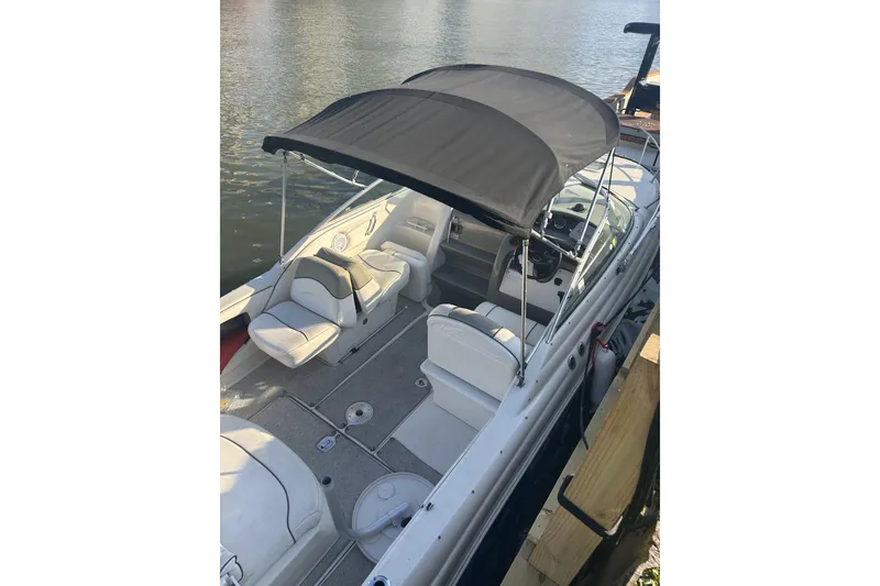 Slide: The Image of 2007 Sea Ray 250 Amberjack boat with canopy by the water. - 5