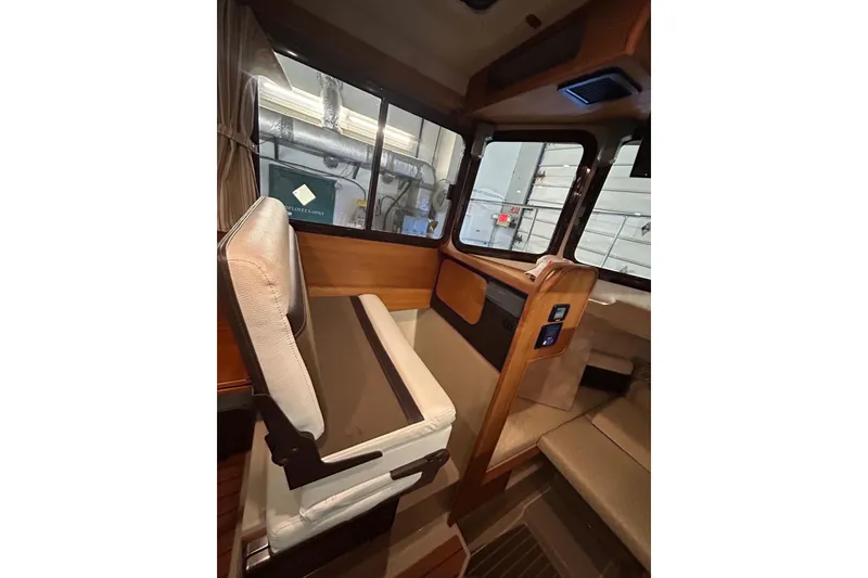 Slide: The Image of 2017 Ranger Tugs R-25 SC interior with seating and control panel. - 14